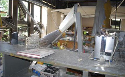 The aftermath of an explosion in a lab.  Debris and damaged structure.
